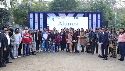 Alumni chatting around a table during the reunion